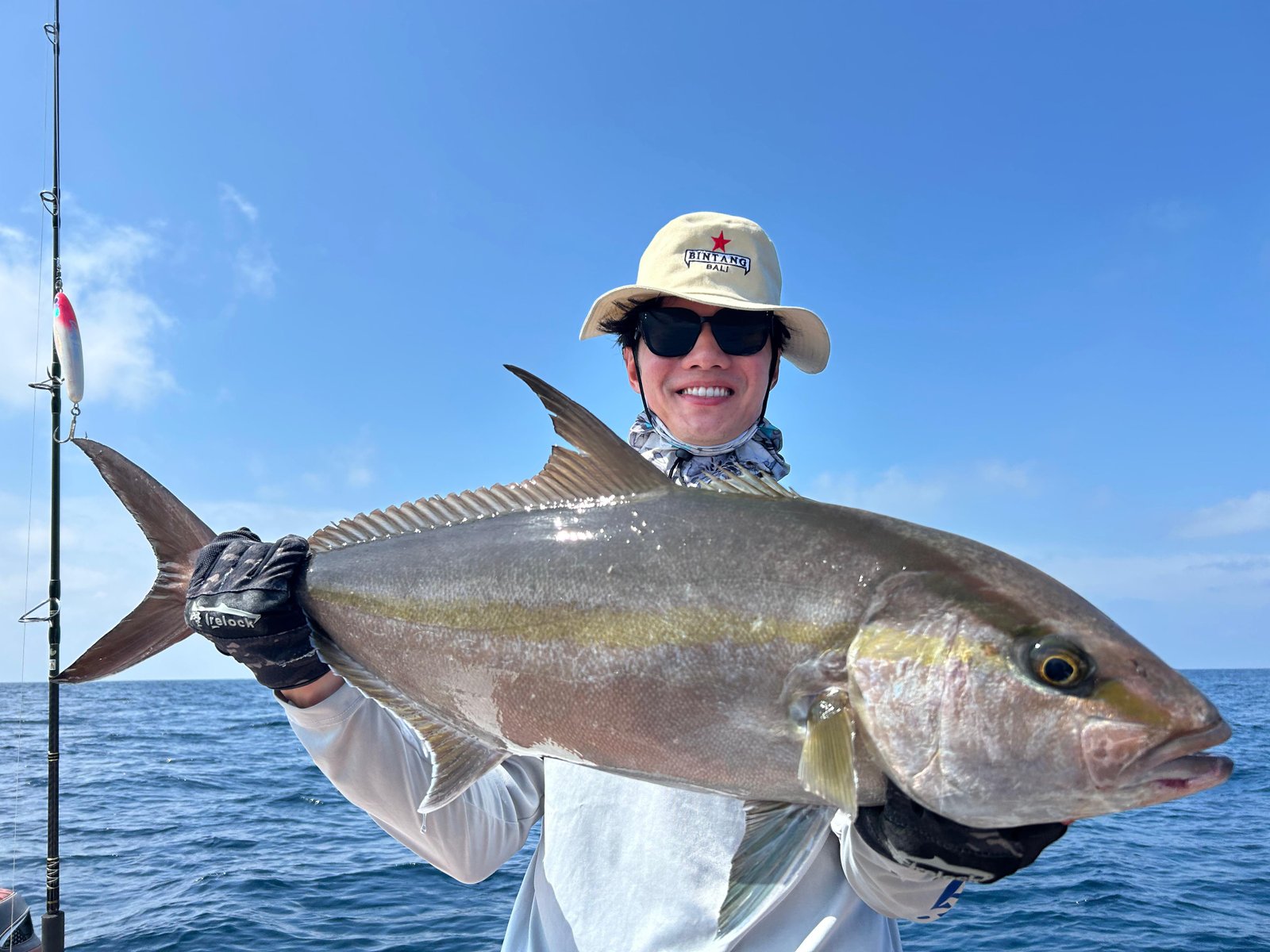 Angler holding giant amberjack during fishing trip in Nusa Penida